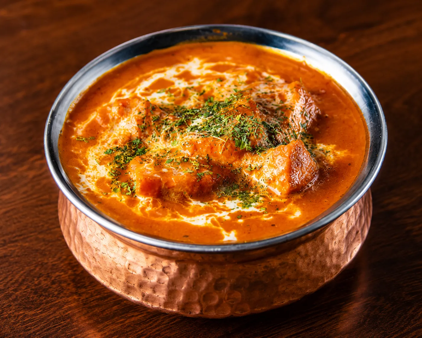Butter chicken curry served with garlic naan at Tamarind East Indian Restaurant in Panorama Hills, Calgary