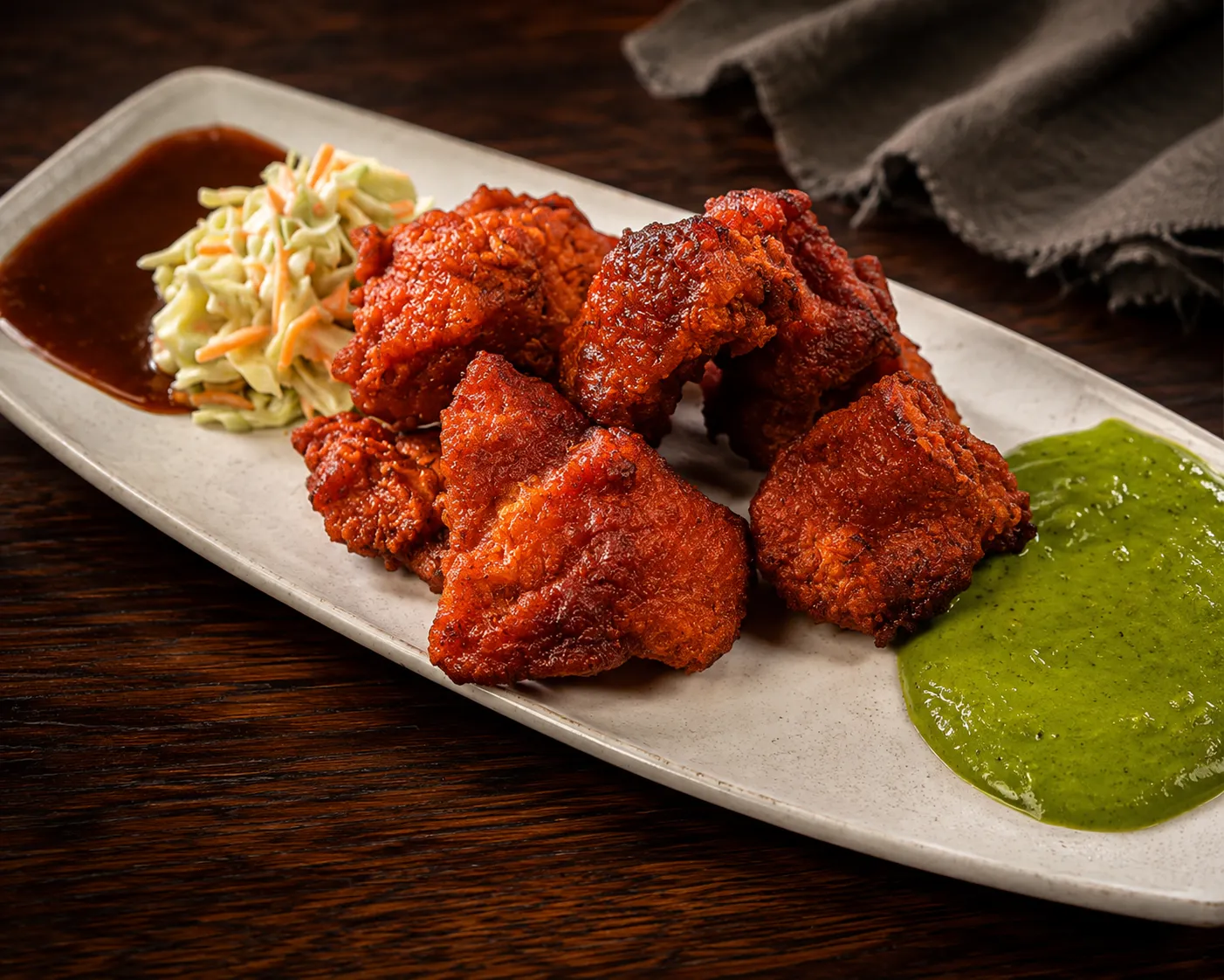 Fish pakora appetizer with mint chutney, lemon and onion at Tamarind East Indian Restaurant Calgary